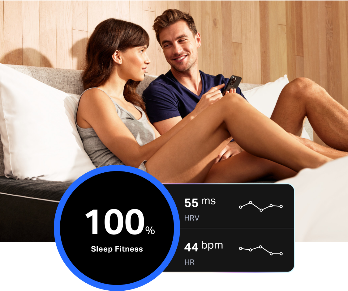 A couple laying on a Pod 3 with a inset screenshot of a Sleep Fitness Report in-app